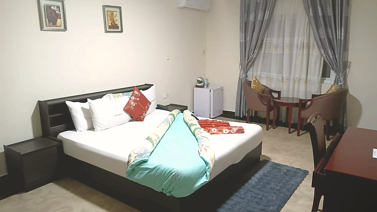Classic Deluxe Room with bed and lounge area at Grand Favor Hotel