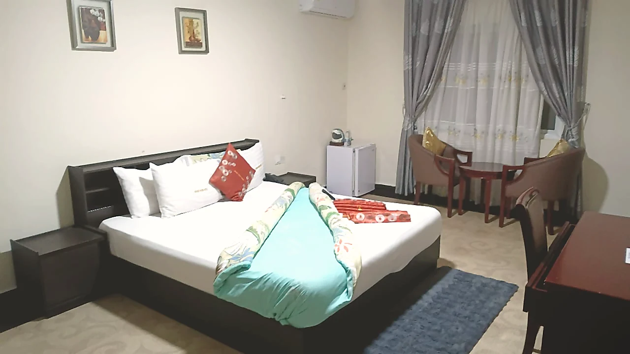 Deluxe room with window lounge and king bed at Grand Favor Hotel