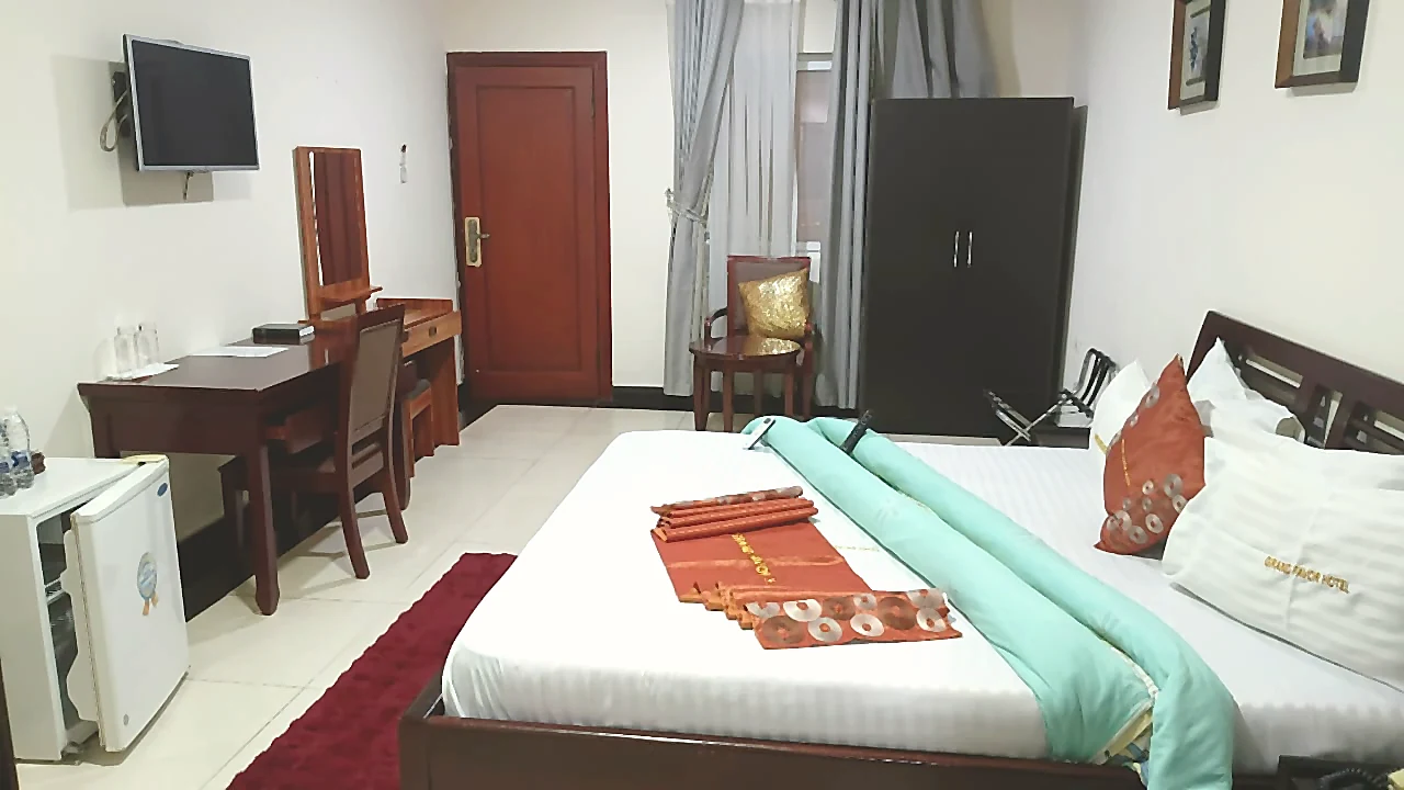 Wide executive room view with bed and work area at Grand Favor Hotel
