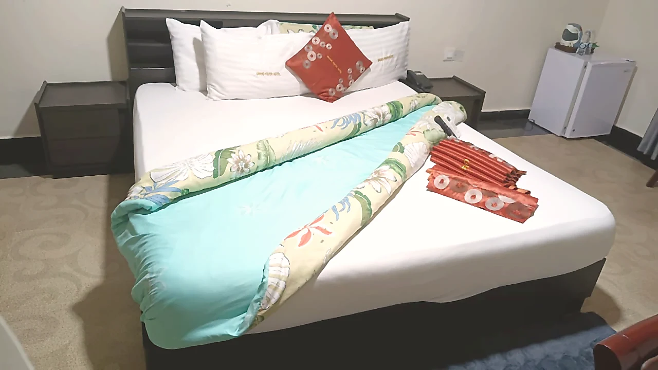 Premium bed detail with fresh linen at Grand Favor Hotel