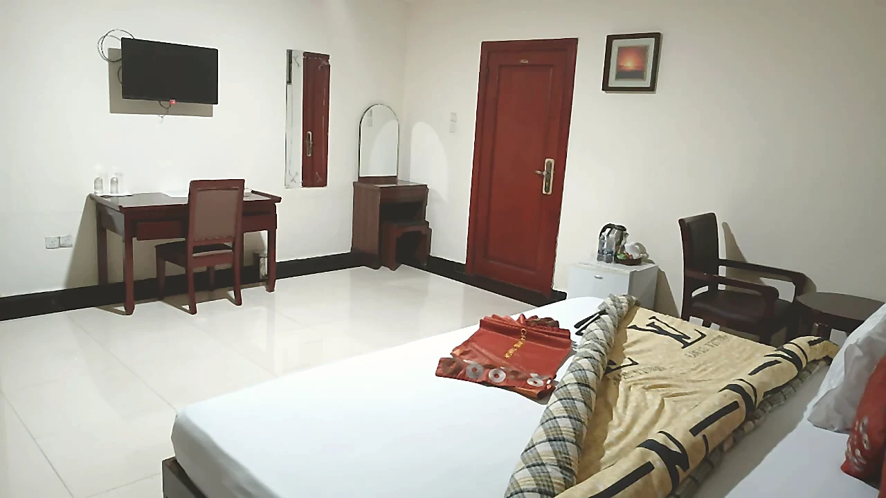Suite corner room with work desk and seating at Grand Favor Hotel